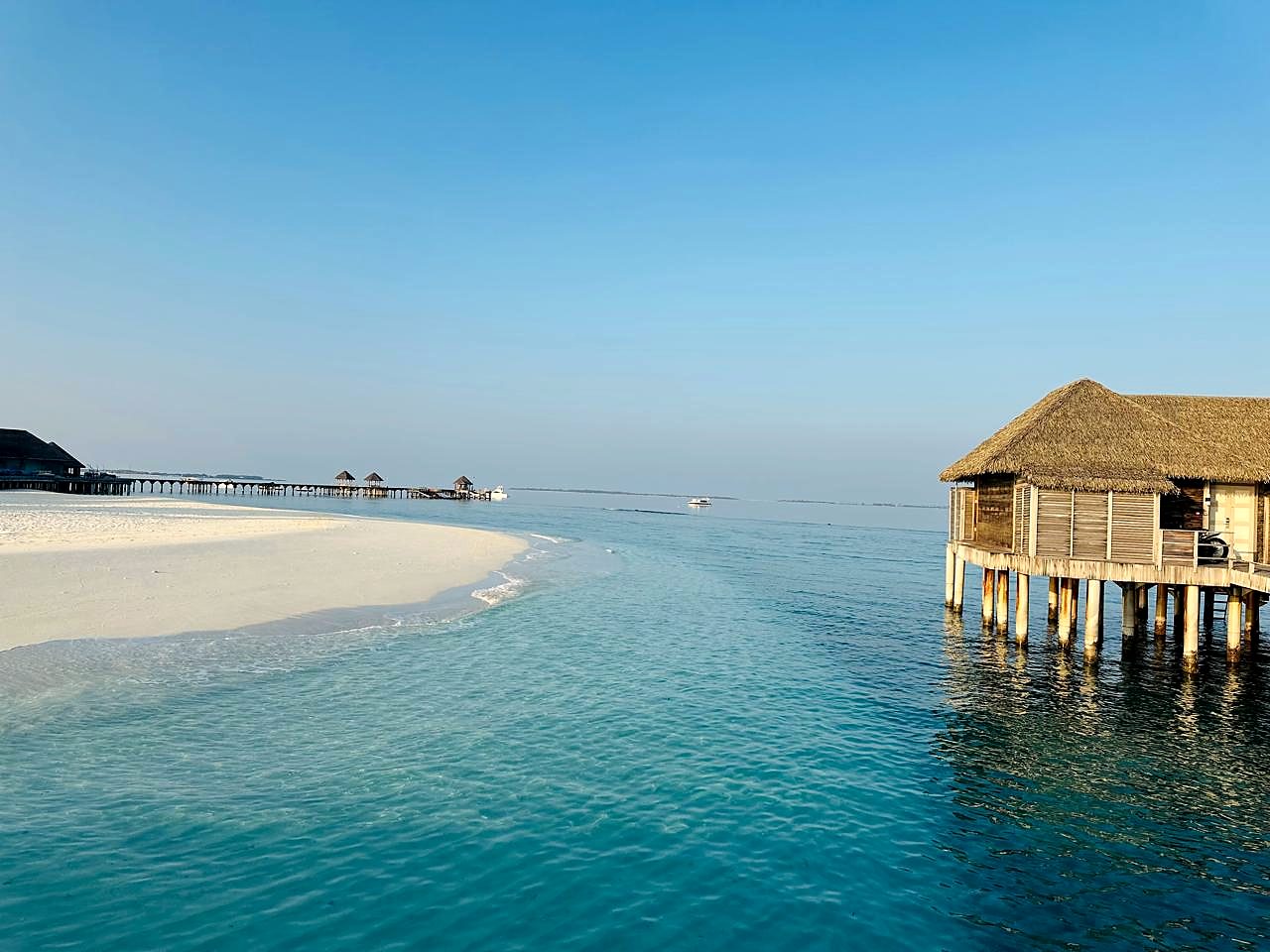 Over-water villa at JA Manafaru, Maldives — luxury beach property scale.